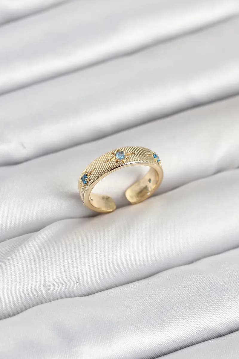 Pirinç Gold Renk Mavi Zirkon Taşlı Kutup Yıldızı Model Kadın Yüzük — fotoğraf 1